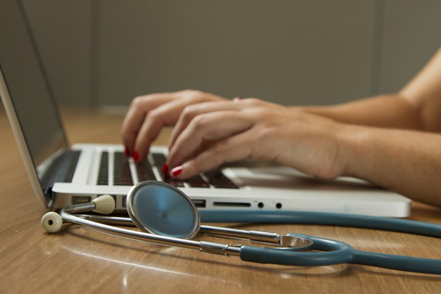 Laptop with stethoscope on a desk